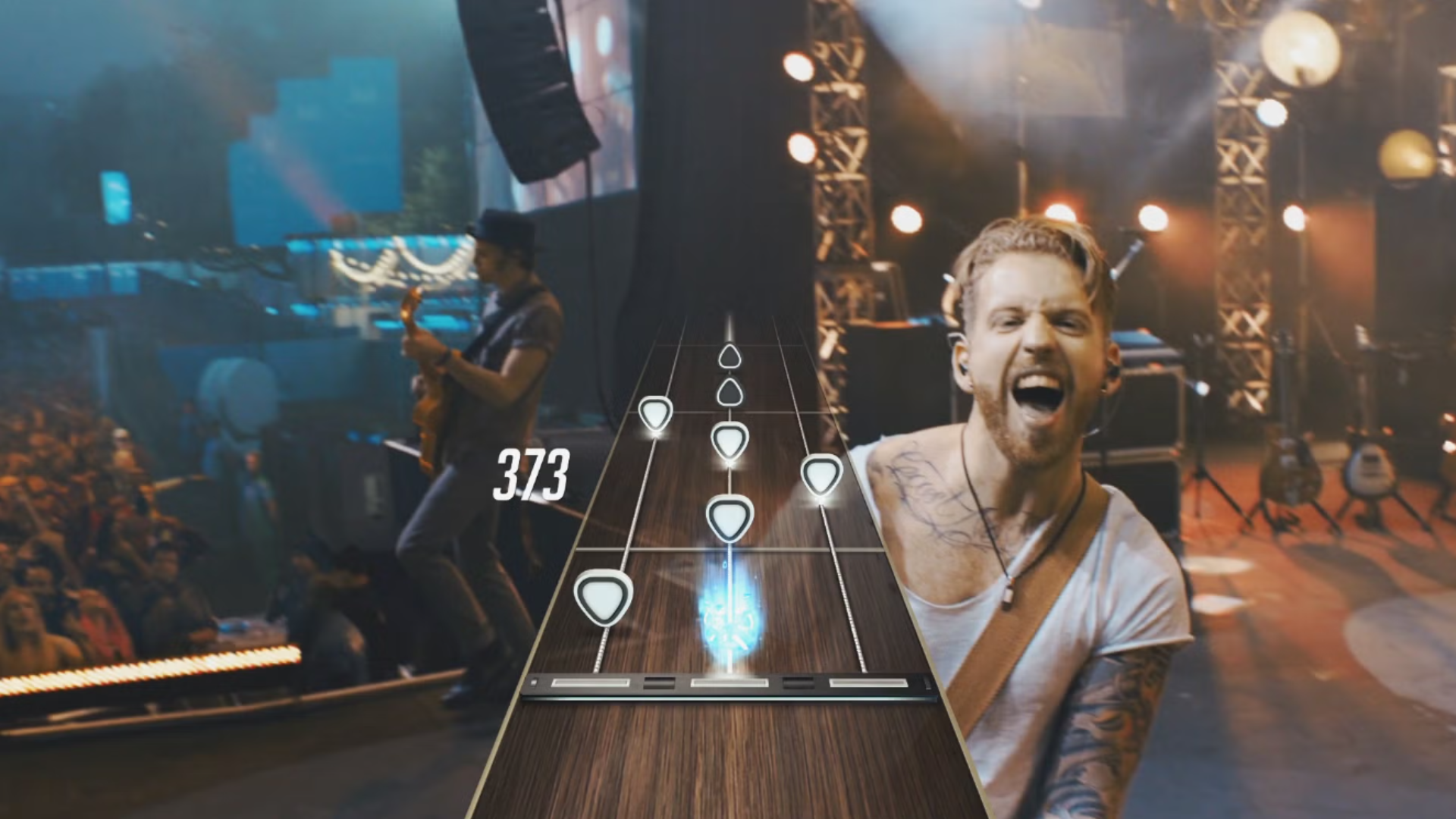 A musician shouts behind the moving UI for a guitar controller in Guitar Hero Live