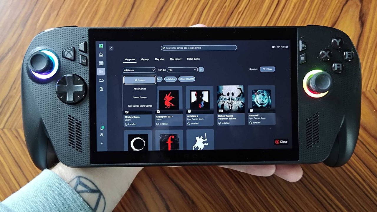Hand holding ROG Xbox Ally X with Xbox app on screen.