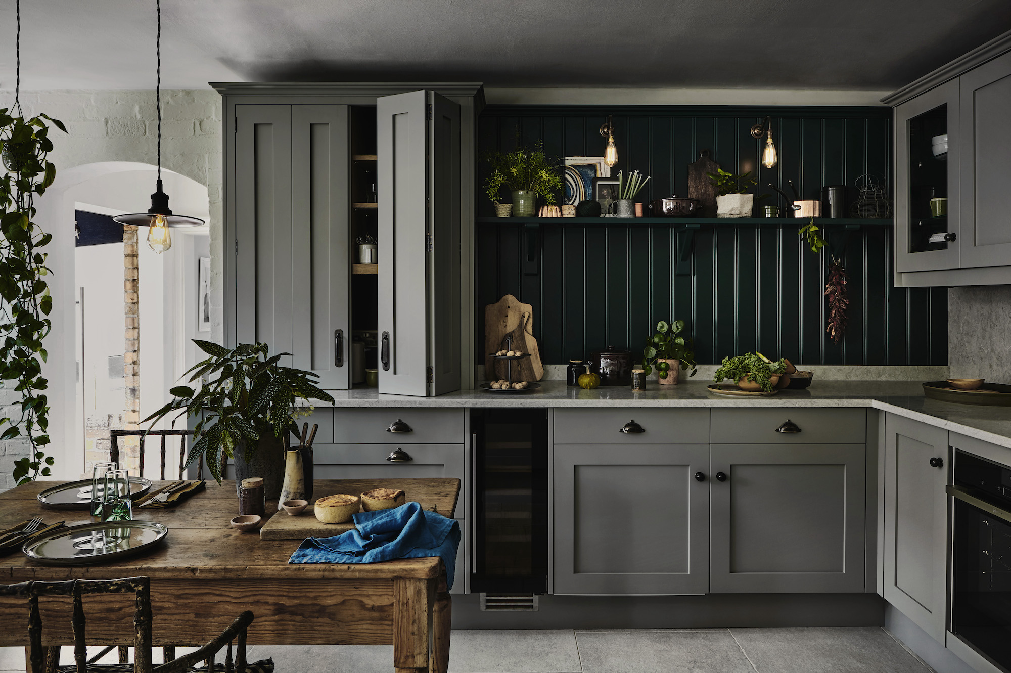 gray shaker kitchen with wood panel splashback