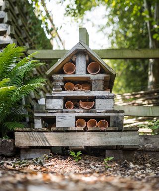 bug hotel in garden made up of old plant pots