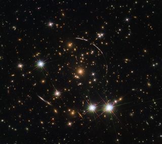 The Hubble Space Telescope recently captured 12 mirror images of the distant, gravitationally-lensed Sunburst Arc. The galaxy can be seen here in this "kaleidoscope" image distributed across four arcs (the elongated lines).