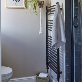 Bathroom with black radiator and towels