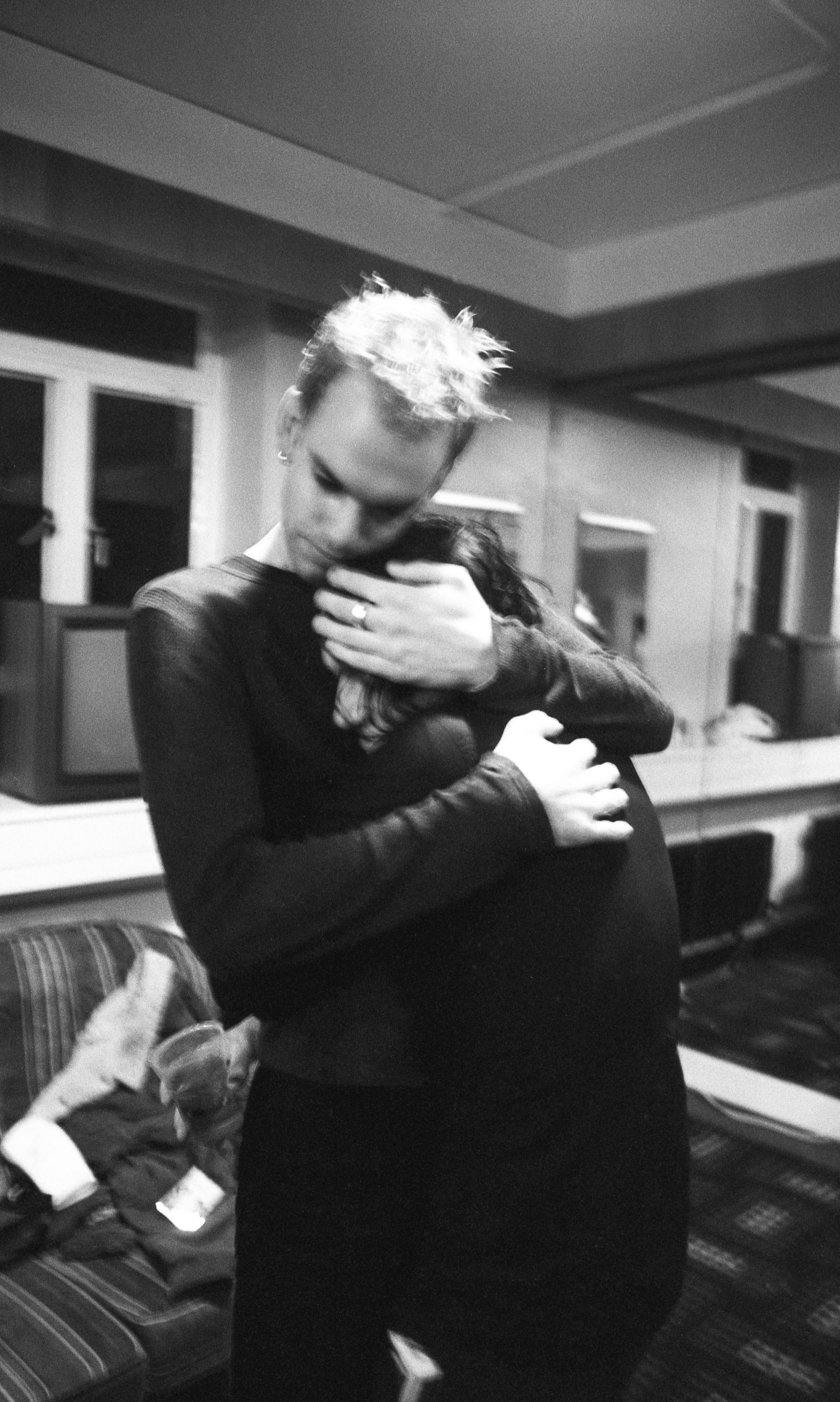 Stefan Olsdal hugs Brian Molko