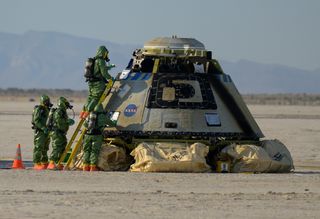 Boeing and NASA teams work around Boeing’s Starliner spacecraft after it landed at White Sands Missile Range’s Space Harbor in New Mexico on May 25, 2022.
