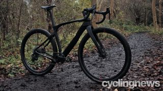 A Pinarello Grevil with its distinctive aero tubing on muddy track in the woods