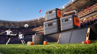 Promotional image showing a Jackery portable power station on the pitch during a football game