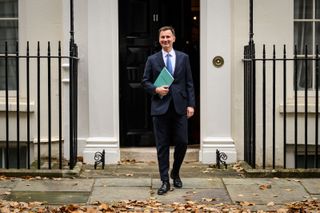 Chancellor of the Exchequer Jeremy Hunt leaves number 11 Downing Street with the Autumn Statement in his hand