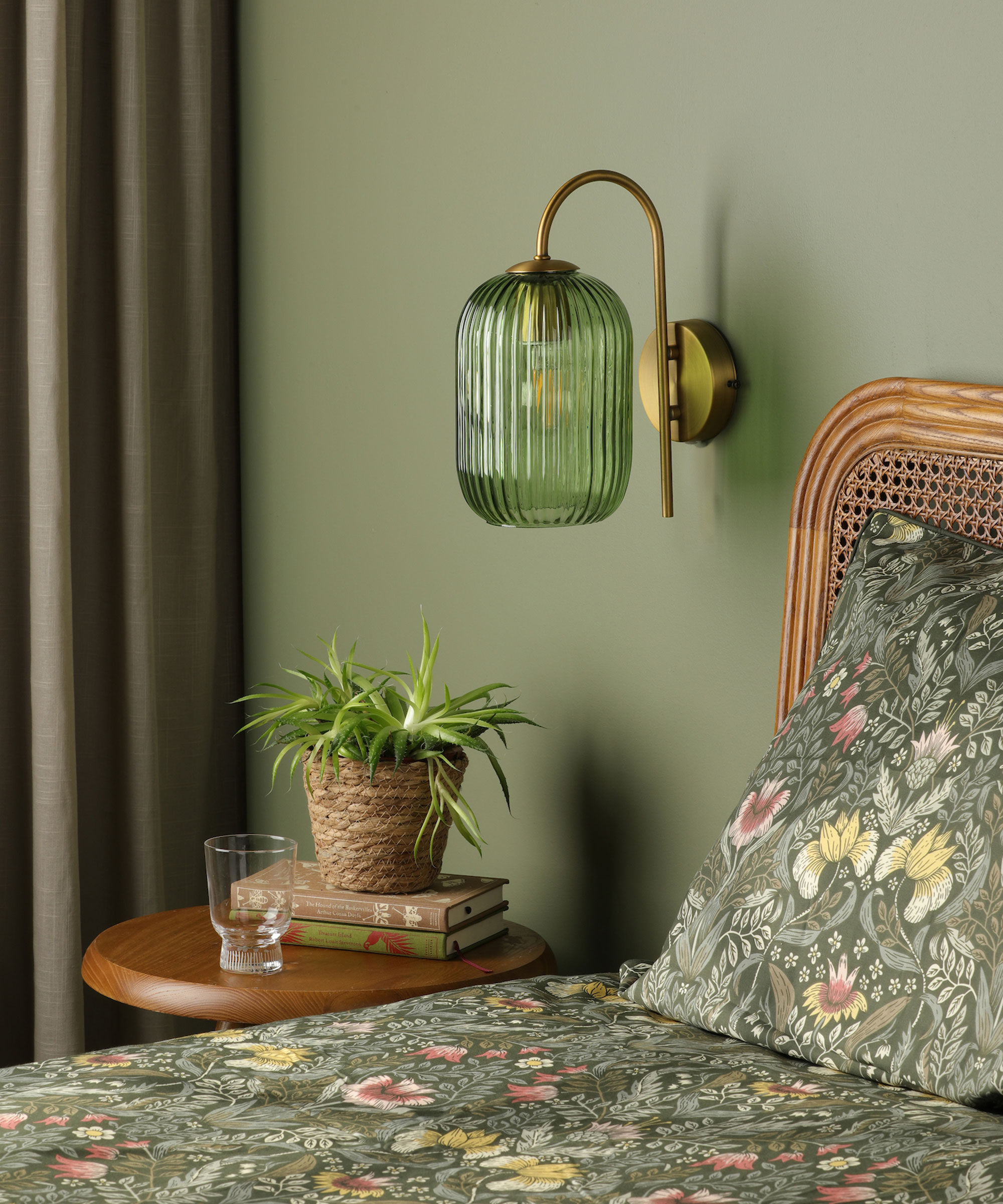 green glass wall-mounted bedside lamp in green bedroom