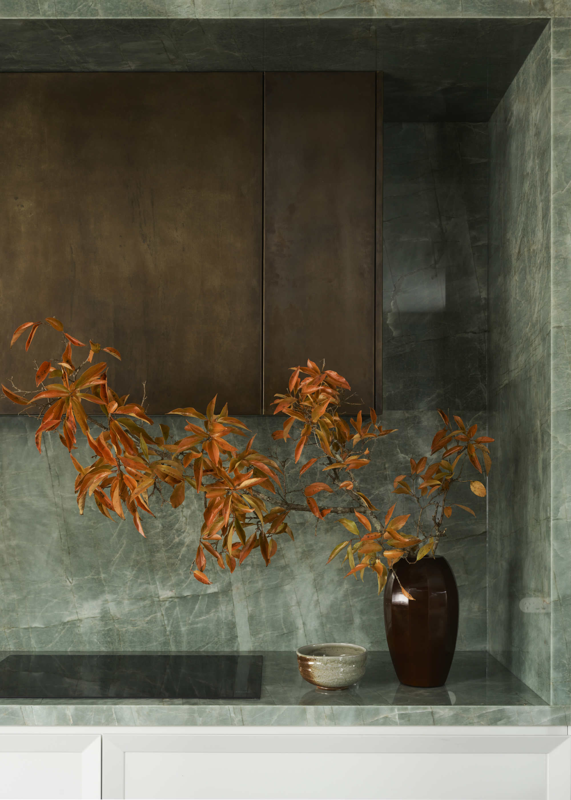 A green quartzite countertop with a large yellow plant
