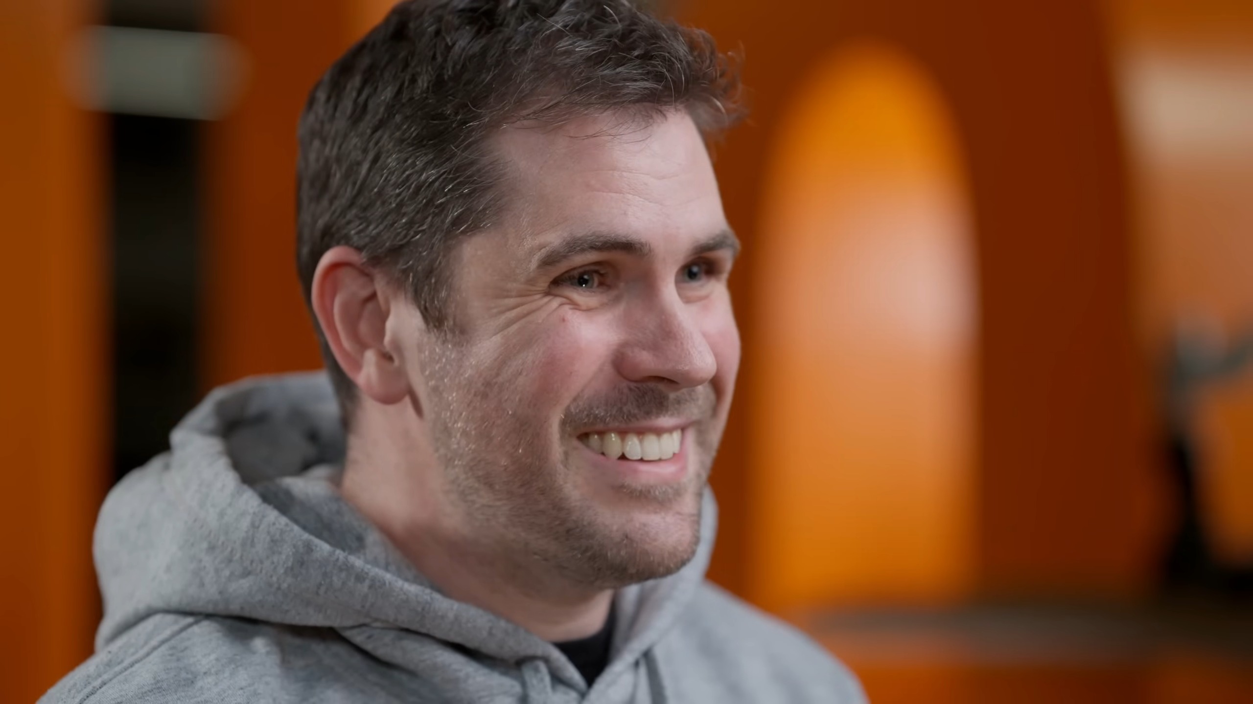 Sean Murray in a gray hoodie smiling