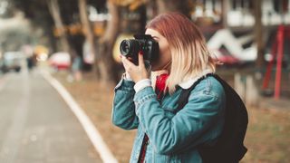 Female student using a DSLR outdoors 