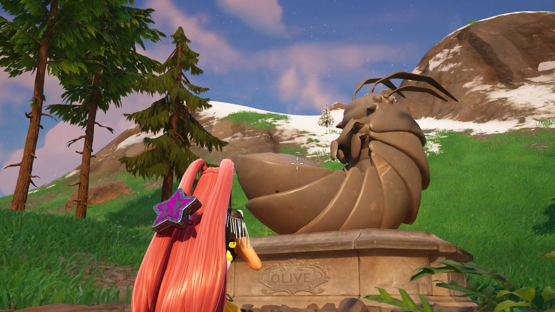 A screenshot in Fortnite shows a pink-haired character crouched by a statue of a roly poly bug, with the name &#039;Olive&#039; on the base of the sculpture.