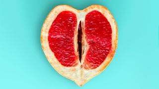 grapefruit in heart shape on blue background