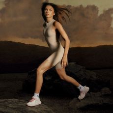 Zendaya wears an On bodysuit with sneakers she designed on a sunset landscape photoshoot set