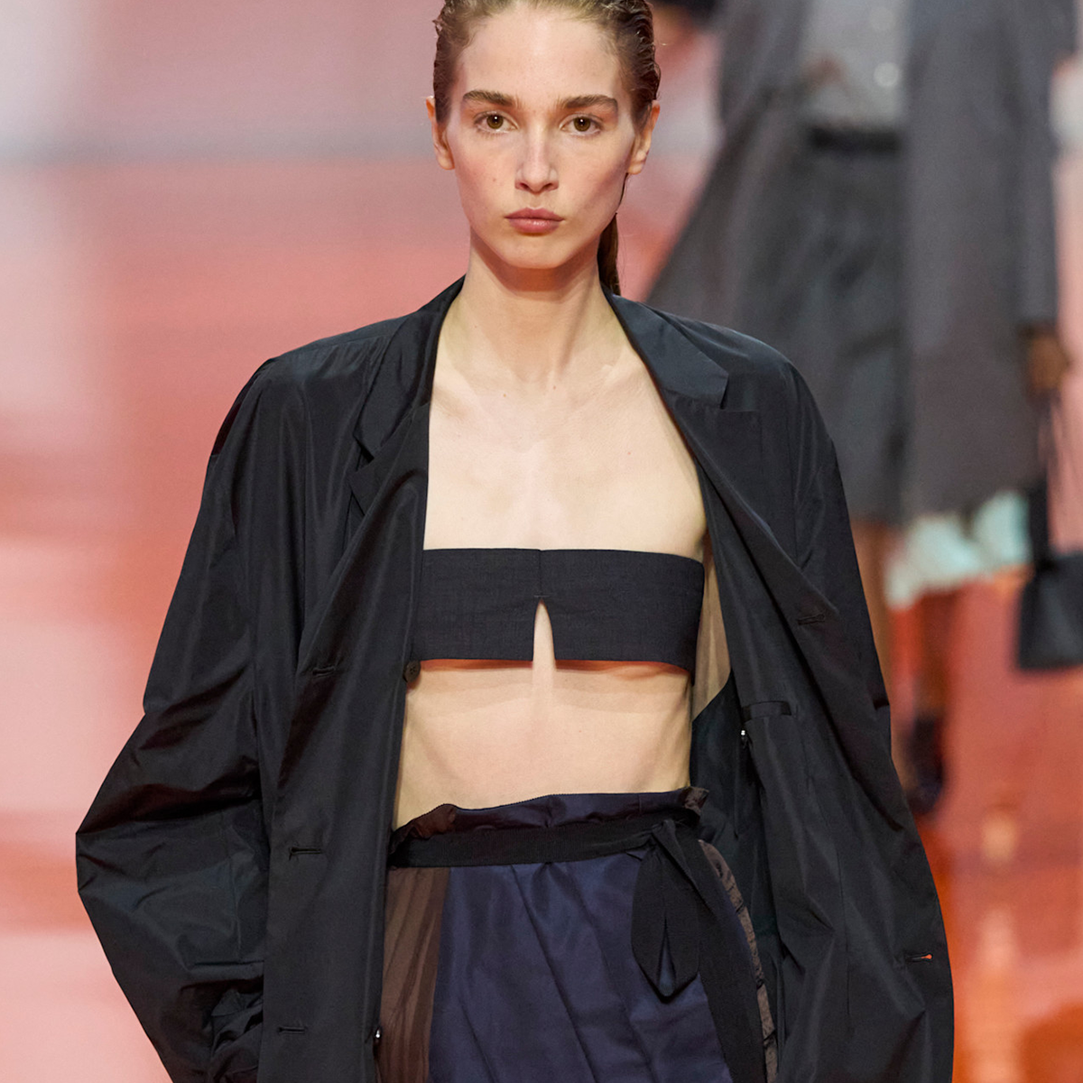 Photo of a model wearing one of the best bandeau bras from the Prada Spring Summer 2026 runway show.