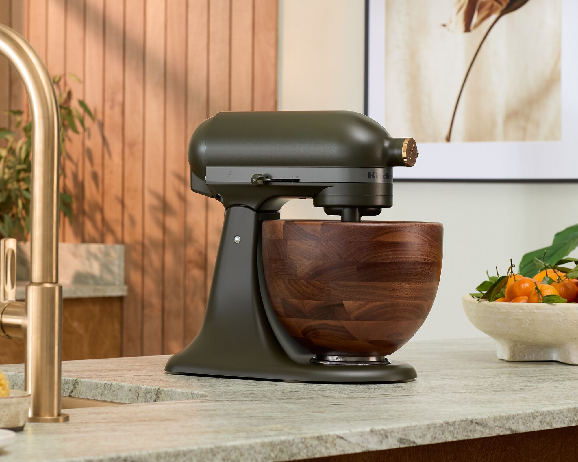 A matt black kitchenaid mixer on a marble surface