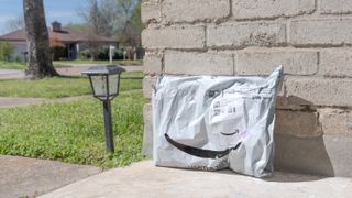 An Amazon package on the side of a front porch