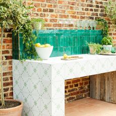 Green tiled splashback in outdoor kitchen