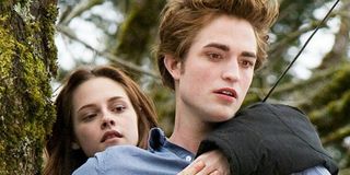 Bella (Kristen Stewart) clings to Edward (Robert Pattinson) in 'Twilight'
