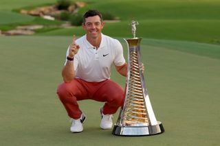 Rory McIlroy posing with the DP World Tour trophy