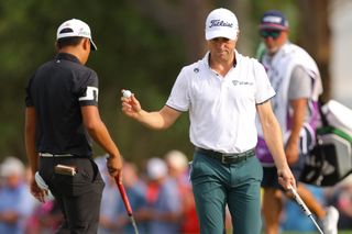 Justin Thomas waves to the crowd