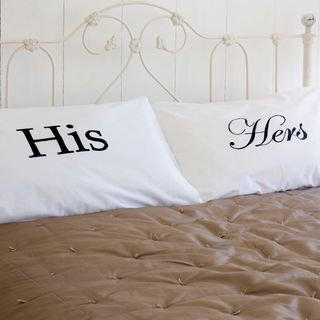 bed with white cushions and shirt