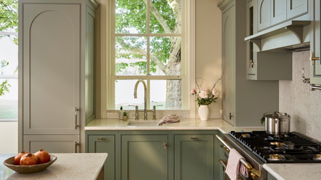 modern shaker kitchen with light sage cabinets and a range oven