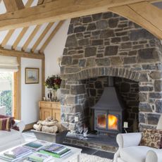 stone fireplace and chimney breast in wood-frame house