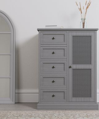 A grey compact master closet by Dunelm with cane detail and five drawers