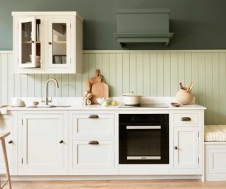 neutral kitchen with pale and dark green walls