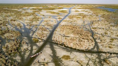 A boat navigates the drought-stricken Chibayish marshes in Iraq's southern Dhi Qar province