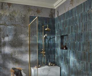 bathroom with shower screen stopping below ceiling height, blue tiles and grey patterned wallpaper