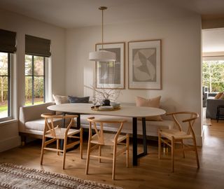 a modern dining room witha banquette seat and roman blinds