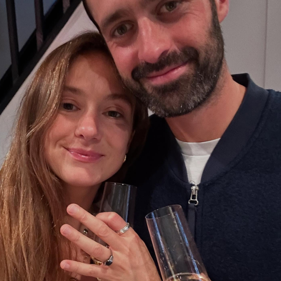 Lady Marina Windsor and her fiance in an engagement photo holding champagne 