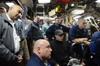 U.S. lawmakers, including Sen. Joe Donnelly (in gray jacket and blue button down), onboard the USS Kentucky submarine to observe a Nov. 7 test launch of a Trident 2 5A missile.