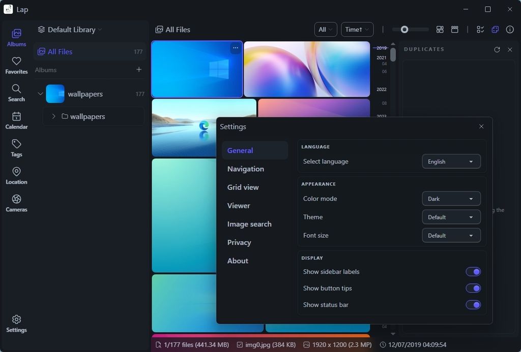 Dark-themed computer interface showing a file management app with thumbnails, a sidebar, and a settings menu. The settings menu includes language and appearance options.
