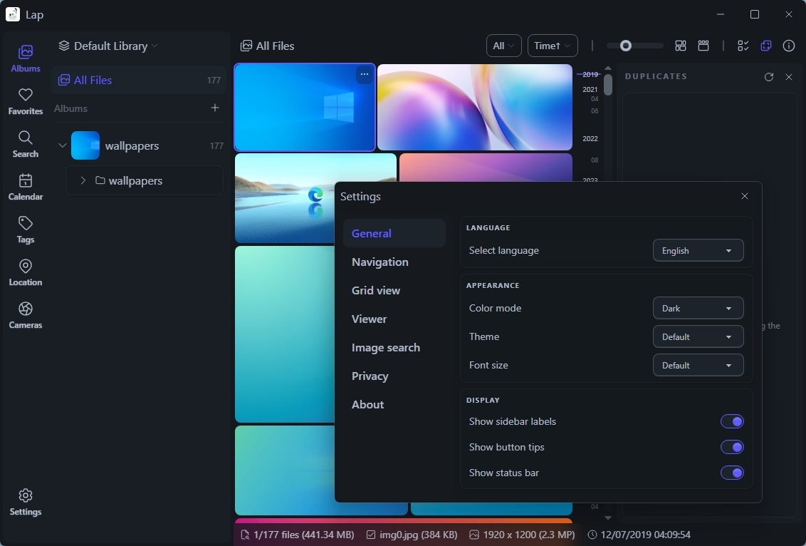 Dark-themed computer interface showing a file management app with thumbnails, a sidebar, and a settings menu. The settings menu includes language and appearance options.