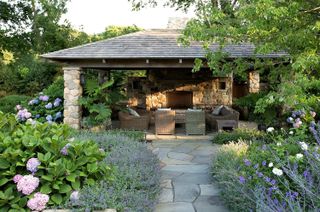 summerhouse ideas with blue and pink hydrangeas and stone walls