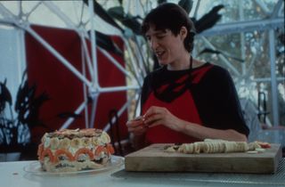 Biospherian Sally Silverstone works on a banana "birthday cake" in Biosphere 2.