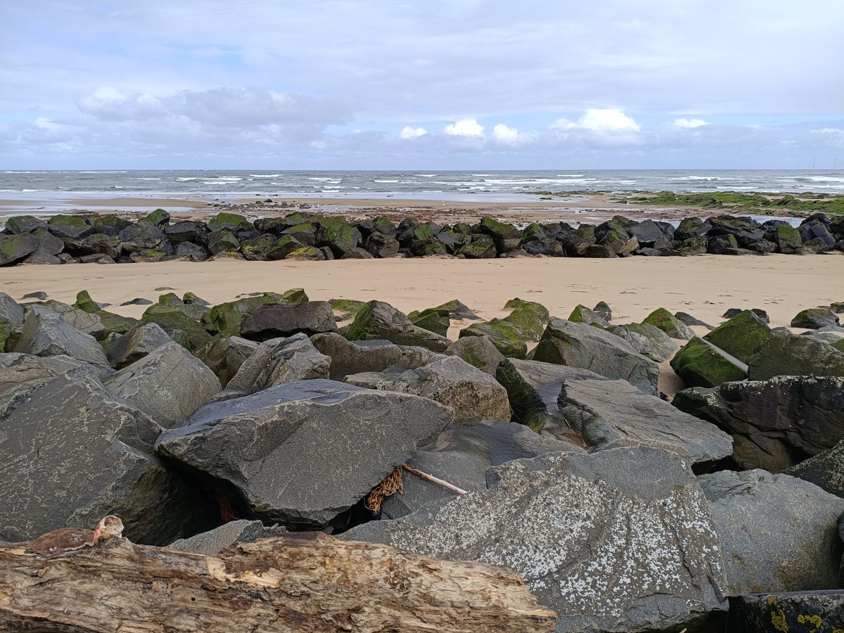 Rocky beach at low tide under a cloudy sky
