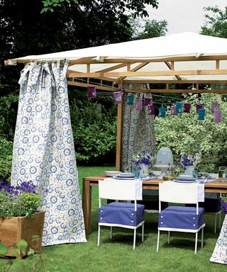 gazebo with patterned curtains and hanging lanterns