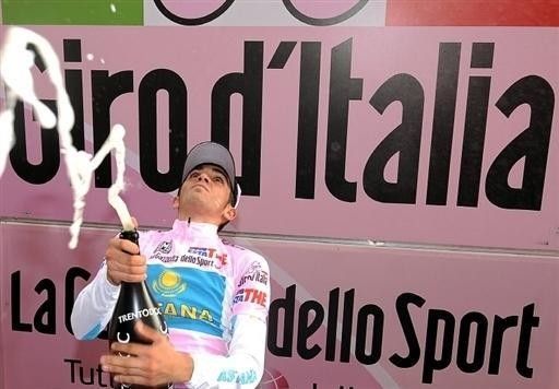 Contador gives the photographers a good soaking.