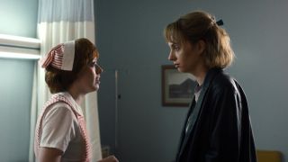 Amybeth McNulty as Vickie and Maya Hawke as Robin stand facing each other on Stranger Things Season 5.