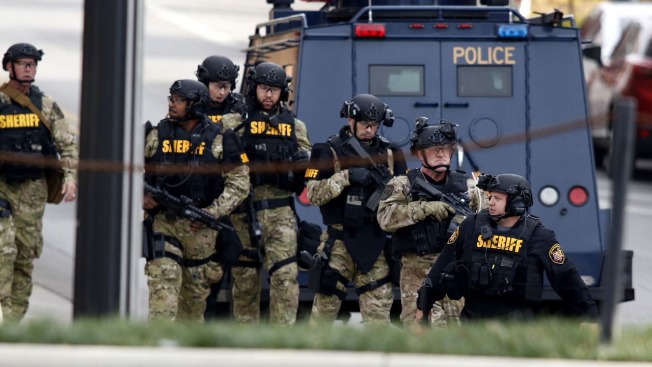 Law enforcement officials are seen outside of a parking garage on the campus of Ohio State University as they respond to an active attack in Columbus, Ohio, on November 28, 2016.Eight people 