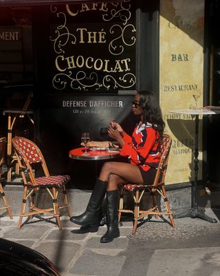 Influencer wears riding boots.