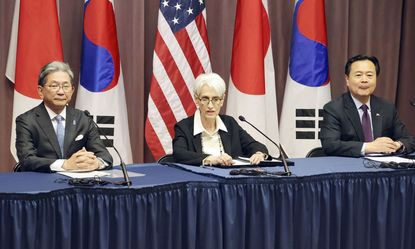 Japanese, American, and South Korean officials during a joint national security meeting.
