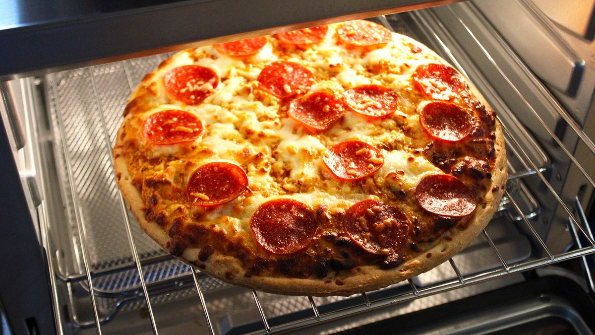 Ninja Prestige Smart XL Air Fryer &amp; Countertop Oven cooking a frozen pizza