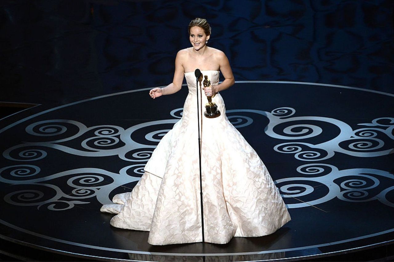 Jennifer Lawrence with her Oscar at the 2013 Oscar ceremony in the most expensive dress ever worn at the Oscars