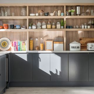 kitchen with wooden shelves and grey cabinets