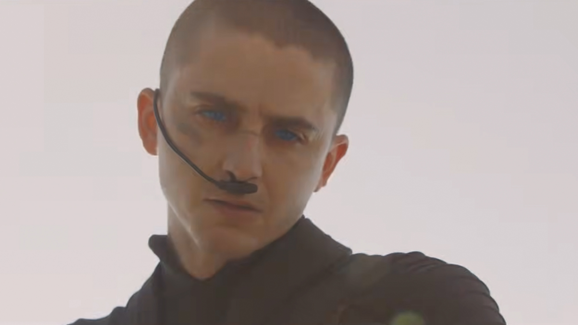 Timothee Chalamet, bald, with a breather on his nose in front of a grey background in Dune 3